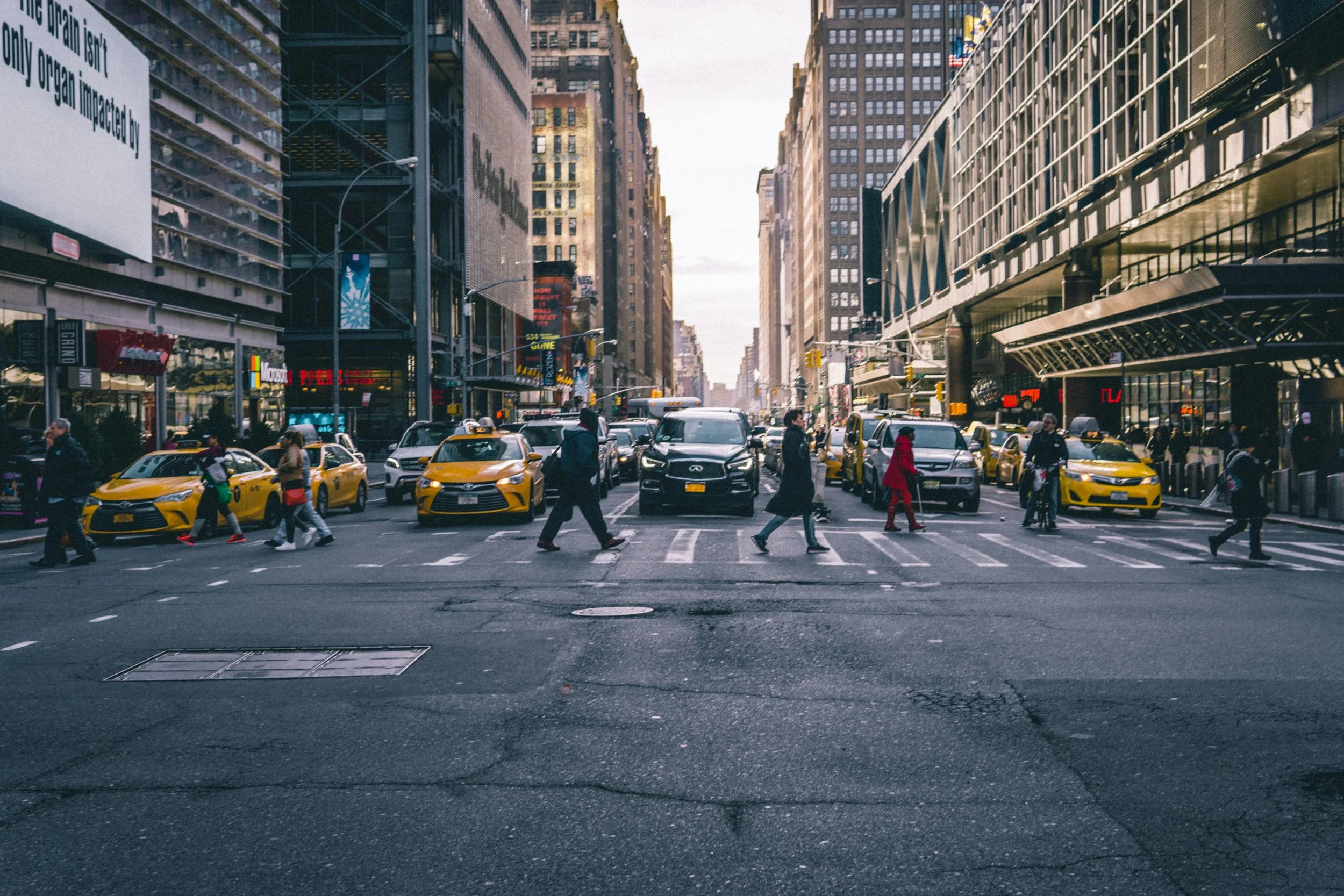Busy city street with pedestrians and taxis