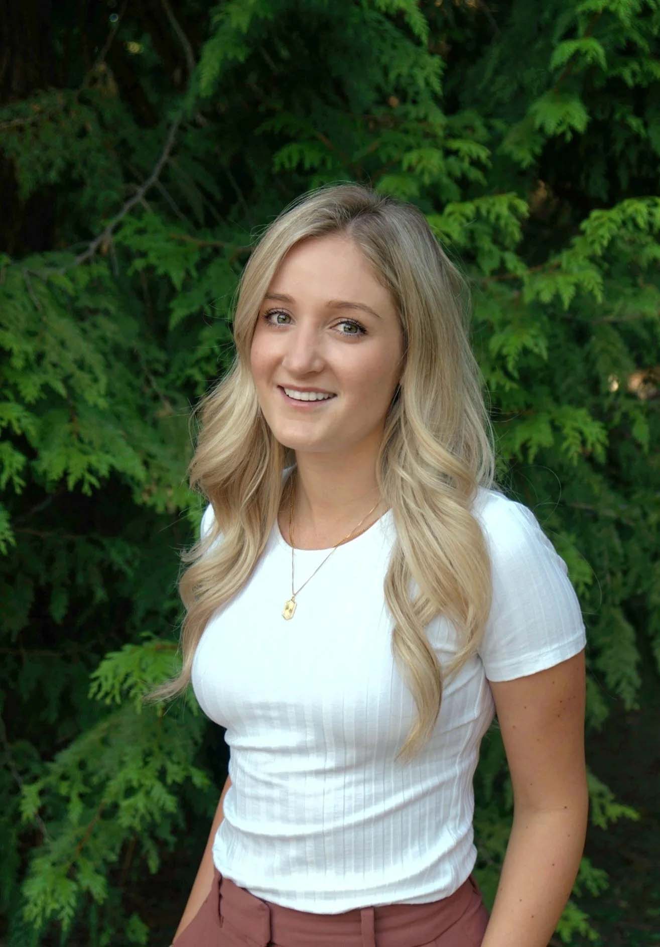 Smiling woman with long hair in nature.